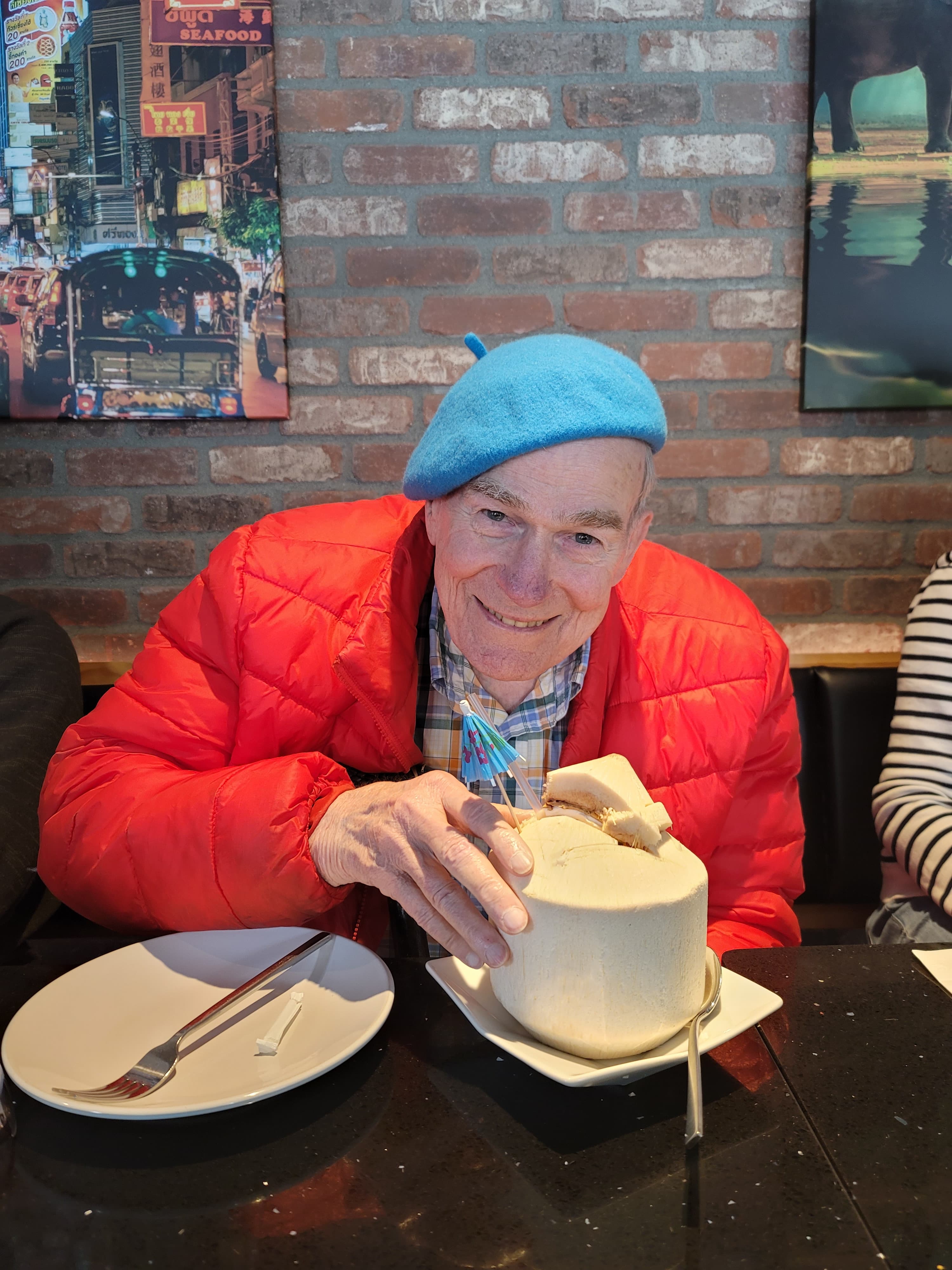 Prof. Goddard enjoying a coconut at a restaurant