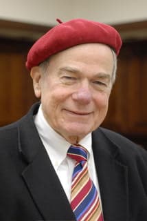 Prof. Goddard — formal portrait with signature red beret